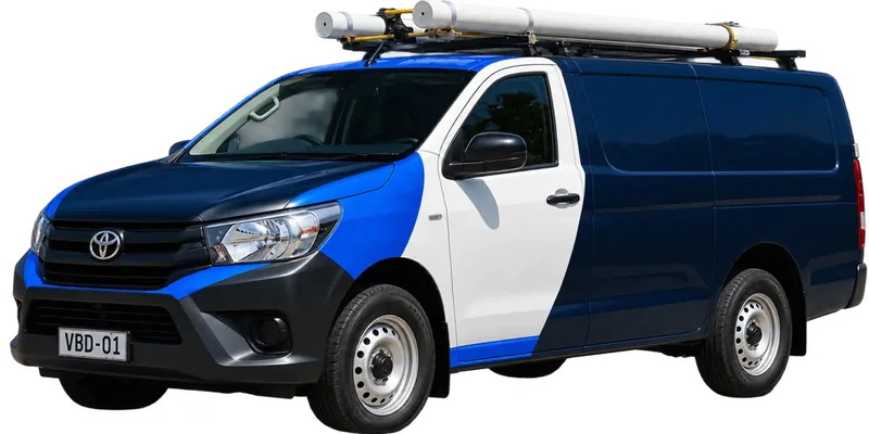 A licensed Castle Hill plumbing van loaded with pipe on the roof rack